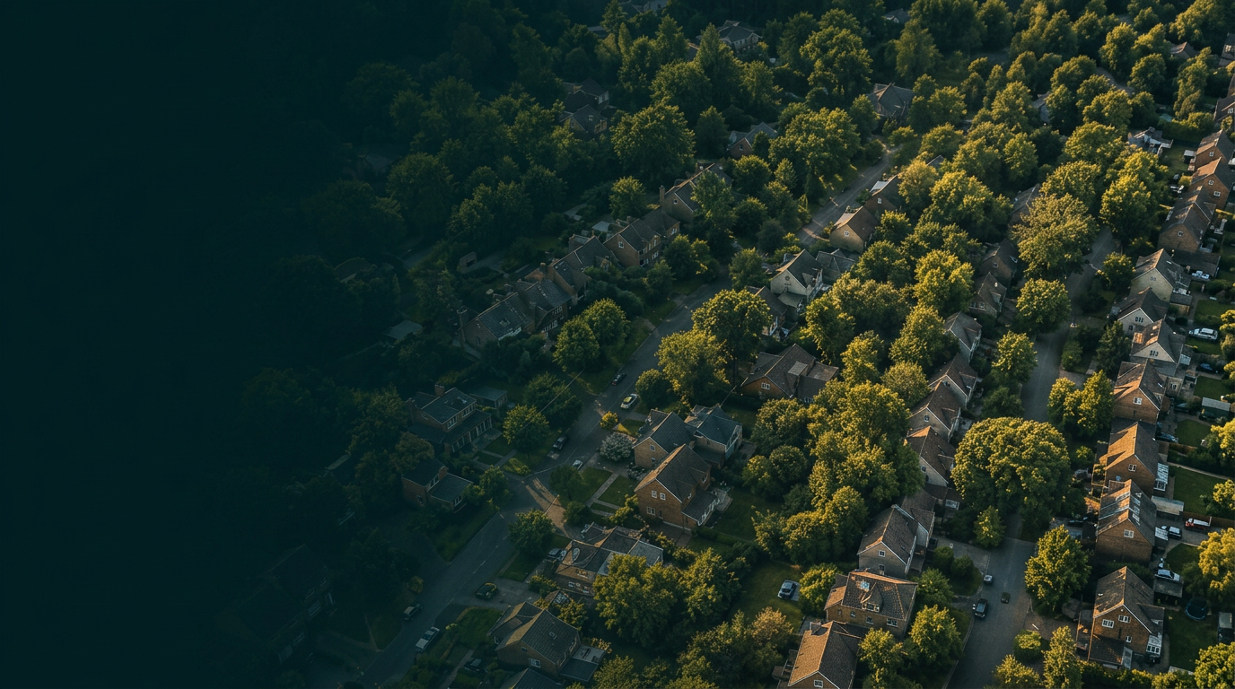 Aerial view of a leafy UK suburban neighbourhood at golden hour
